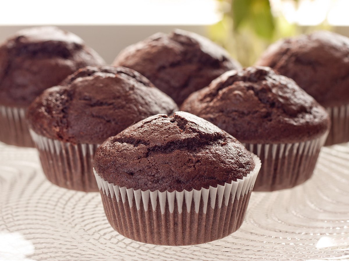 Muffinförmchen werden mit Teig gefüllt