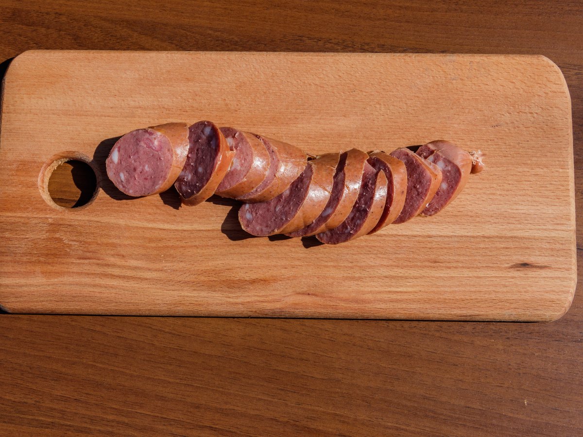 Geräucherte Wurst in Scheiben auf einem Holzbrett