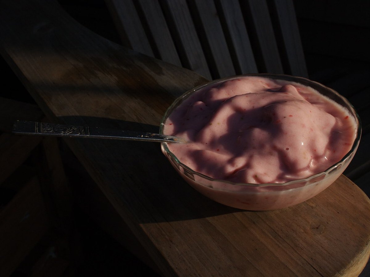 Milch, Eis und Erdbeeren neben dem Mixer