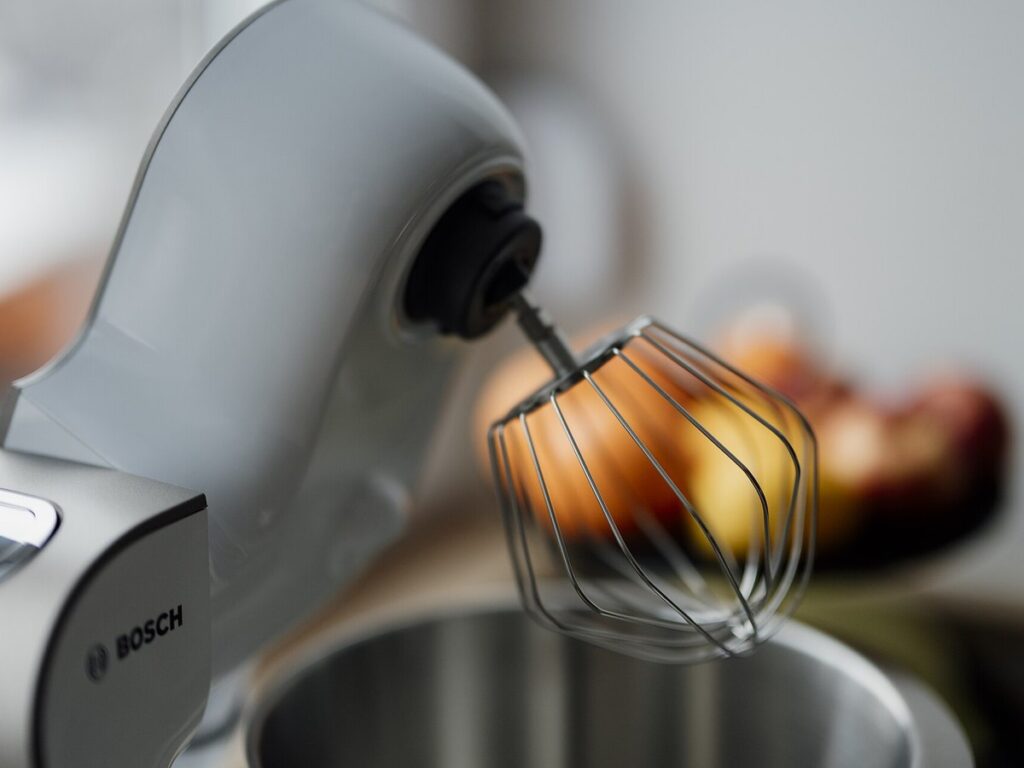 Mixing batter with kitchen mixer while preparing for baking session